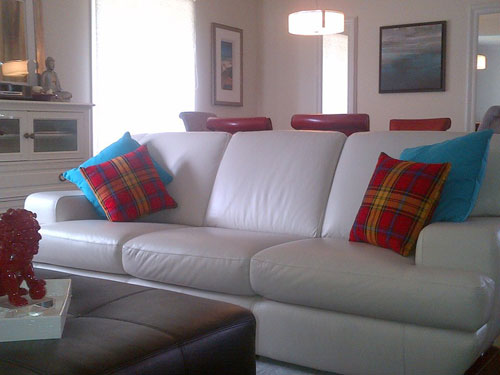 Rourke Frew cotton pillows on a white leather couch